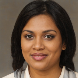 Joyful black young-adult female with medium  brown hair and brown eyes