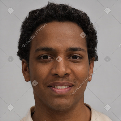 Joyful black young-adult male with short  brown hair and brown eyes
