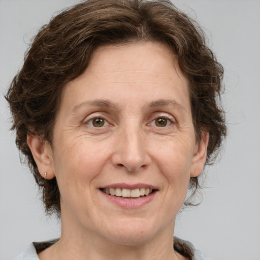 Joyful white adult female with medium  brown hair and grey eyes