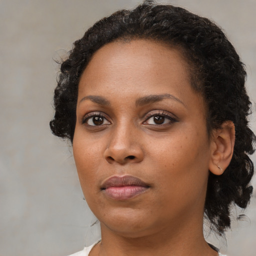 Neutral black young-adult female with medium  brown hair and brown eyes
