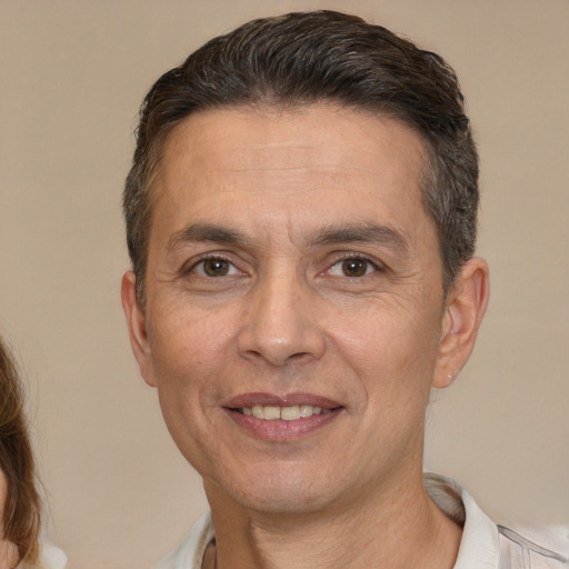 Joyful white adult male with short  brown hair and brown eyes