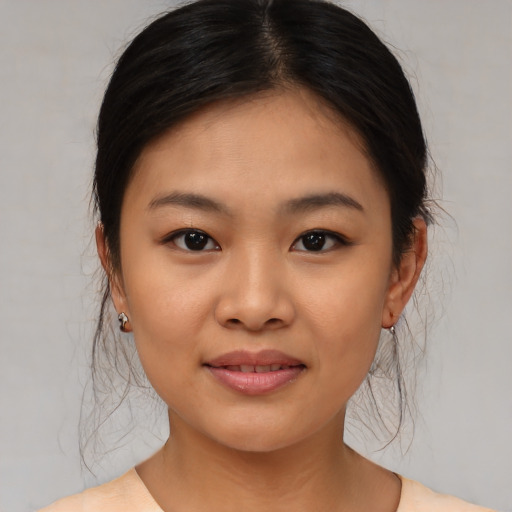 Joyful asian young-adult female with medium  brown hair and brown eyes