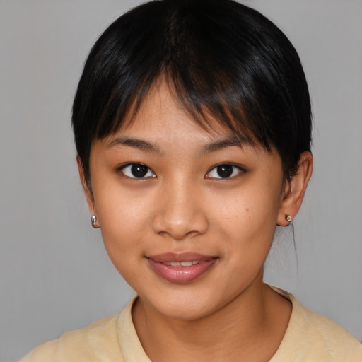 Joyful asian young-adult female with medium  brown hair and brown eyes