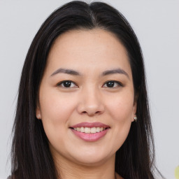 Joyful asian young-adult female with long  brown hair and brown eyes