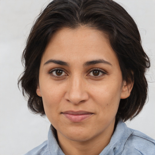 Joyful white adult female with medium  brown hair and brown eyes