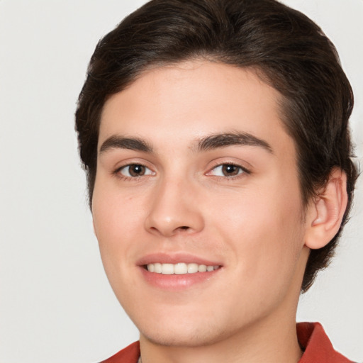 Joyful white young-adult male with medium  brown hair and brown eyes