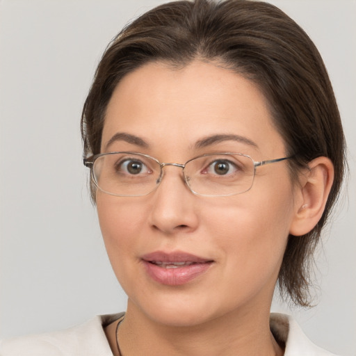 Joyful white adult female with medium  brown hair and brown eyes