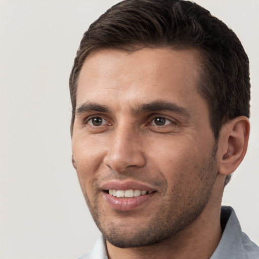 Joyful white young-adult male with short  brown hair and brown eyes