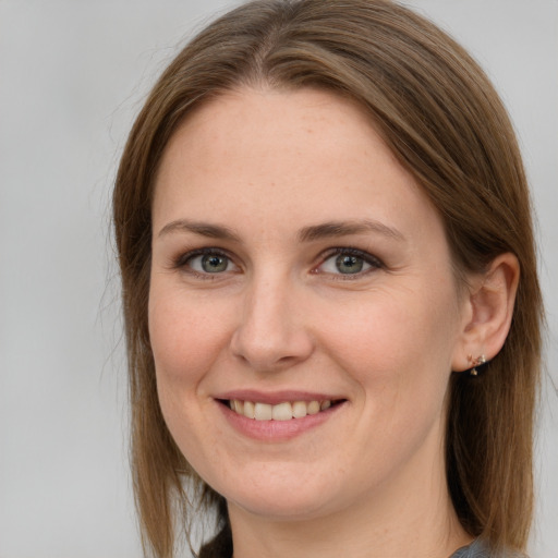 Joyful white young-adult female with long  brown hair and grey eyes