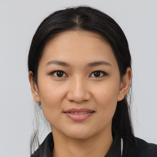 Joyful white young-adult female with medium  black hair and brown eyes