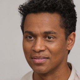 Joyful black adult male with short  black hair and brown eyes