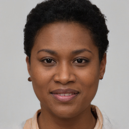 Joyful black young-adult female with short  brown hair and brown eyes