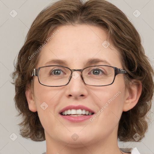 Joyful white adult female with medium  brown hair and green eyes