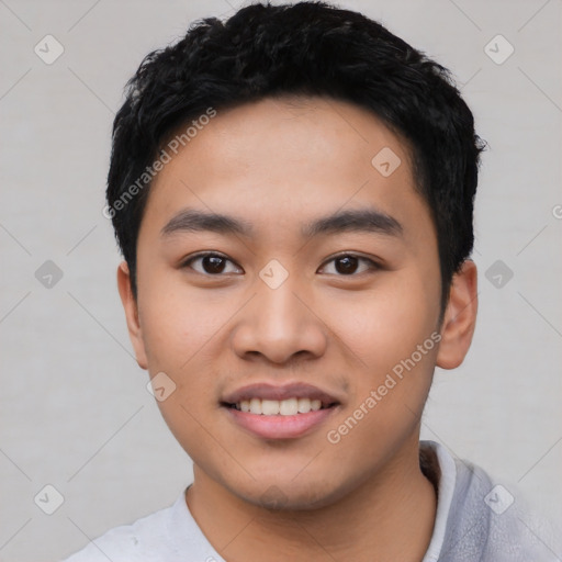 Joyful asian young-adult male with short  black hair and brown eyes