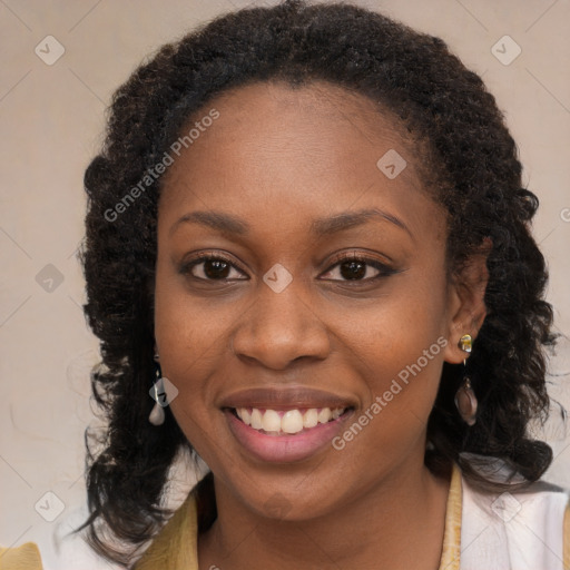 Joyful black young-adult female with long  brown hair and brown eyes