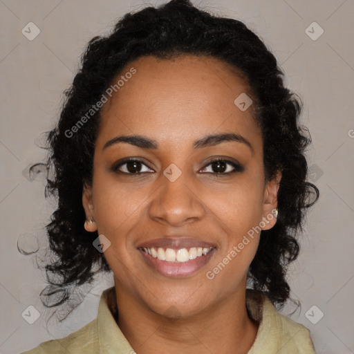 Joyful black young-adult female with long  black hair and brown eyes