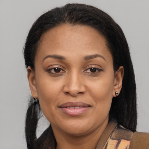 Joyful black adult female with medium  brown hair and brown eyes