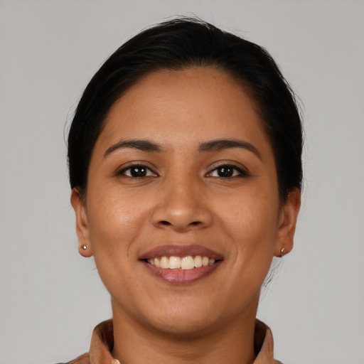 Joyful latino young-adult female with short  black hair and brown eyes