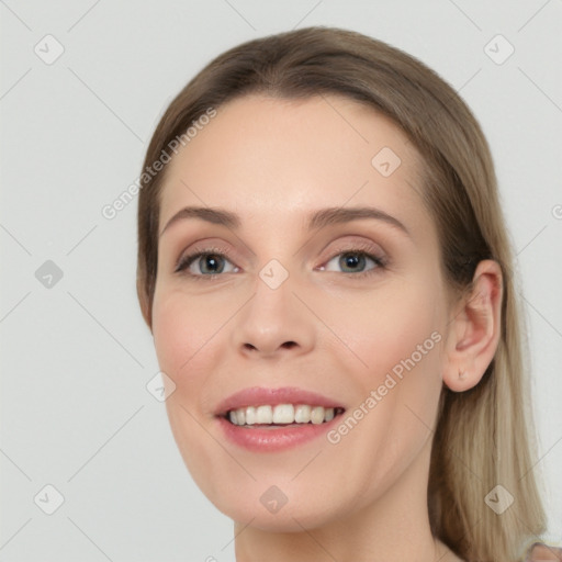 Joyful white young-adult female with long  brown hair and green eyes