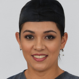 Joyful latino young-adult female with short  black hair and brown eyes