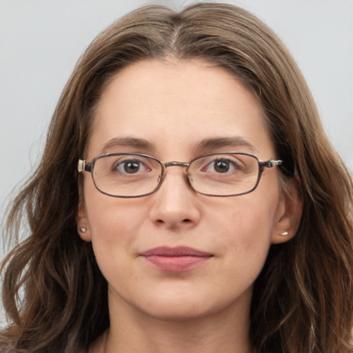 Joyful white young-adult female with long  brown hair and grey eyes