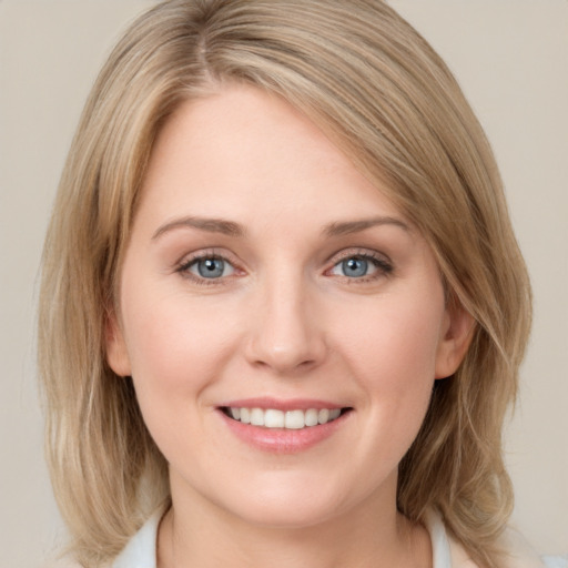 Joyful white young-adult female with medium  brown hair and blue eyes