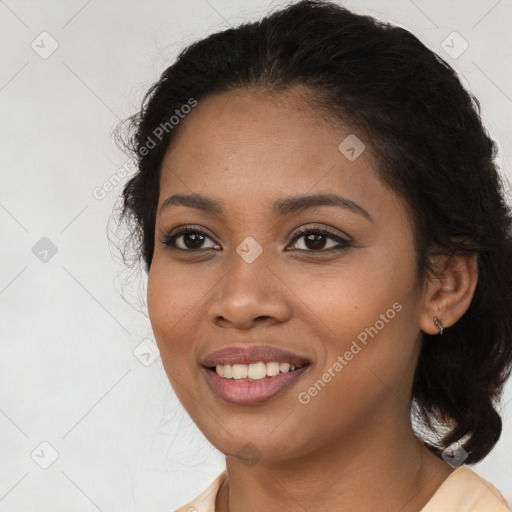 Joyful black young-adult female with long  brown hair and brown eyes