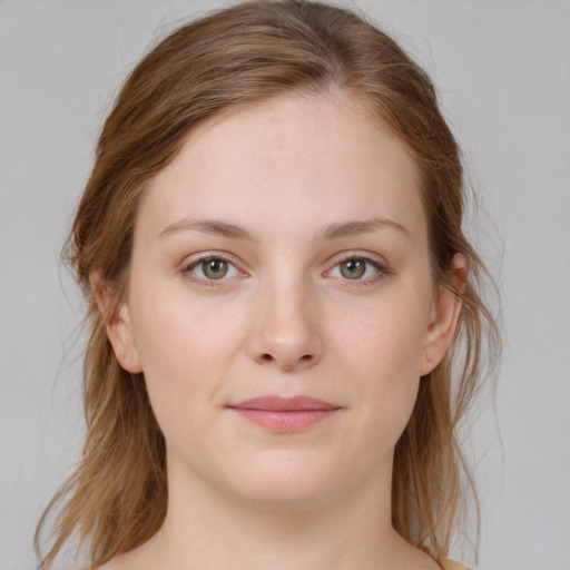 Joyful white young-adult female with medium  brown hair and blue eyes