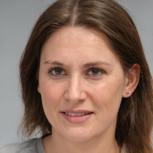 Joyful white adult female with medium  brown hair and brown eyes