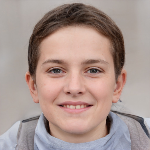 Joyful white child male with short  brown hair and grey eyes