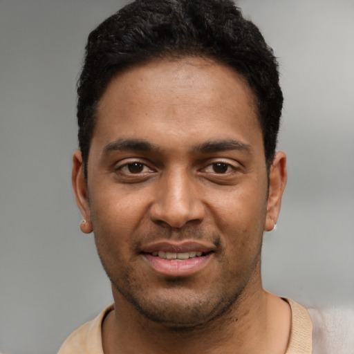 Joyful black young-adult male with short  black hair and brown eyes