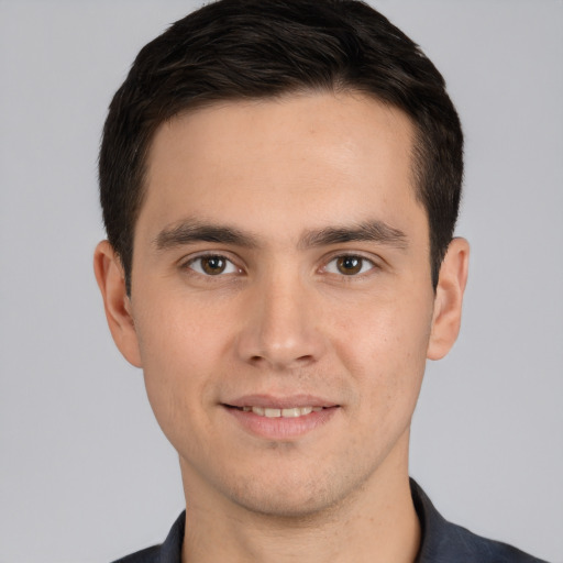 Joyful white young-adult male with short  brown hair and brown eyes