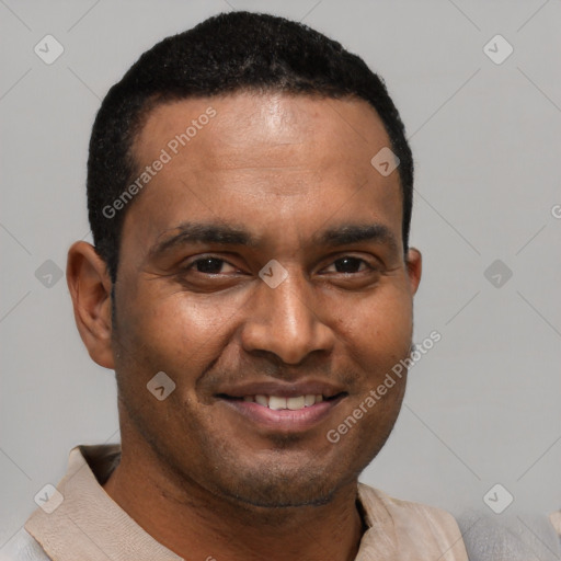 Joyful black young-adult male with short  brown hair and brown eyes