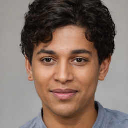 Joyful white young-adult male with short  black hair and brown eyes