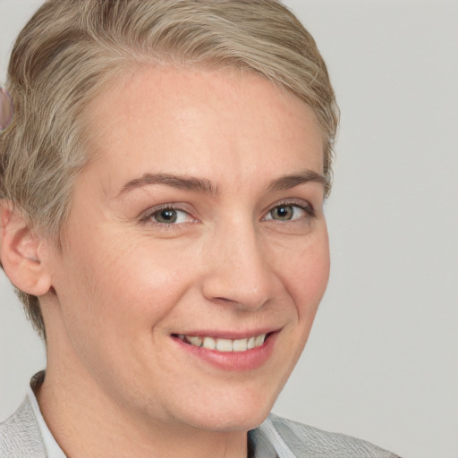 Joyful white adult female with short  brown hair and brown eyes