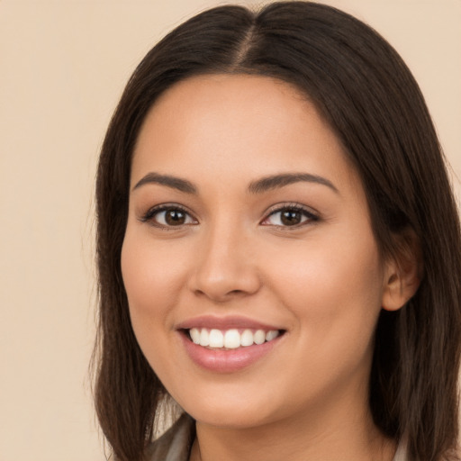 Joyful white young-adult female with long  brown hair and brown eyes