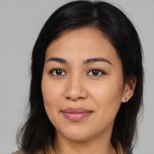 Joyful latino young-adult female with long  brown hair and brown eyes