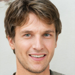 Joyful white adult male with short  brown hair and grey eyes