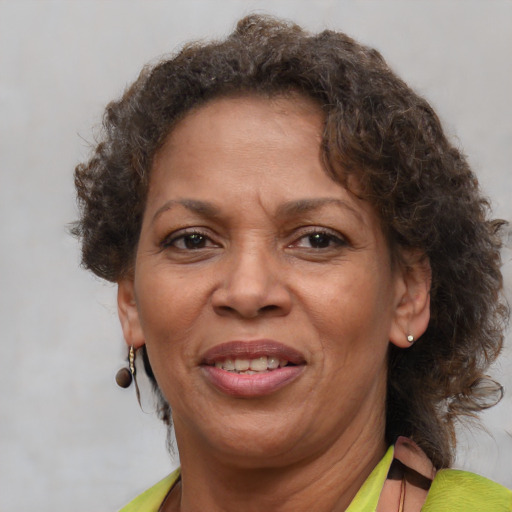 Joyful black adult female with short  brown hair and brown eyes