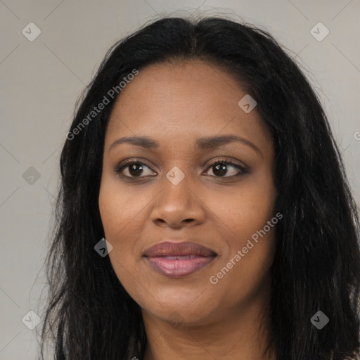 Joyful black young-adult female with long  black hair and brown eyes