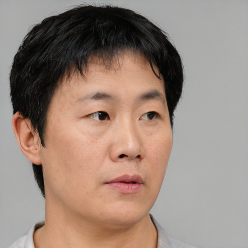 Neutral asian young-adult male with short  black hair and brown eyes