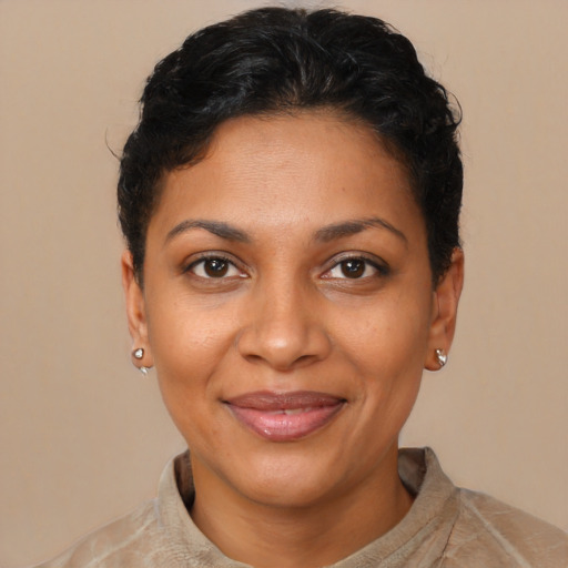 Joyful latino young-adult female with short  black hair and brown eyes