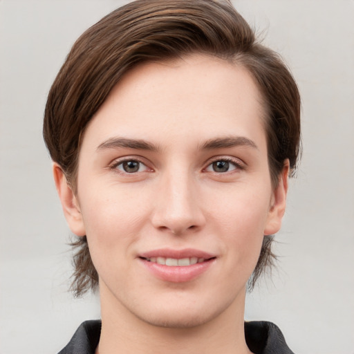 Joyful white young-adult female with short  brown hair and grey eyes