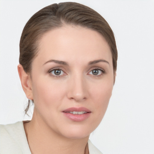 Joyful white young-adult female with medium  brown hair and grey eyes