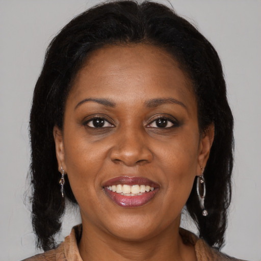 Joyful black young-adult female with medium  brown hair and brown eyes