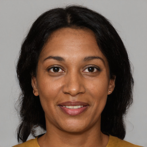 Joyful black adult female with medium  black hair and brown eyes