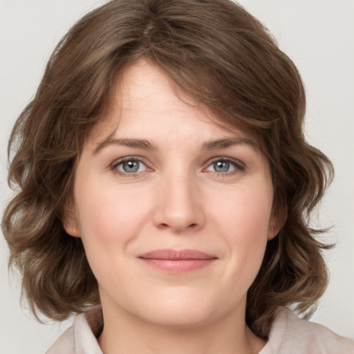 Joyful white young-adult female with medium  brown hair and green eyes