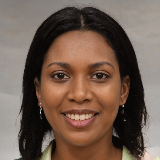 Joyful black young-adult female with medium  black hair and brown eyes