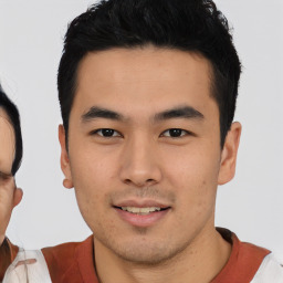 Joyful asian young-adult male with short  black hair and brown eyes