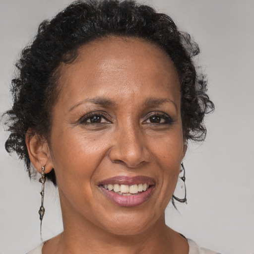 Joyful black adult female with short  brown hair and brown eyes